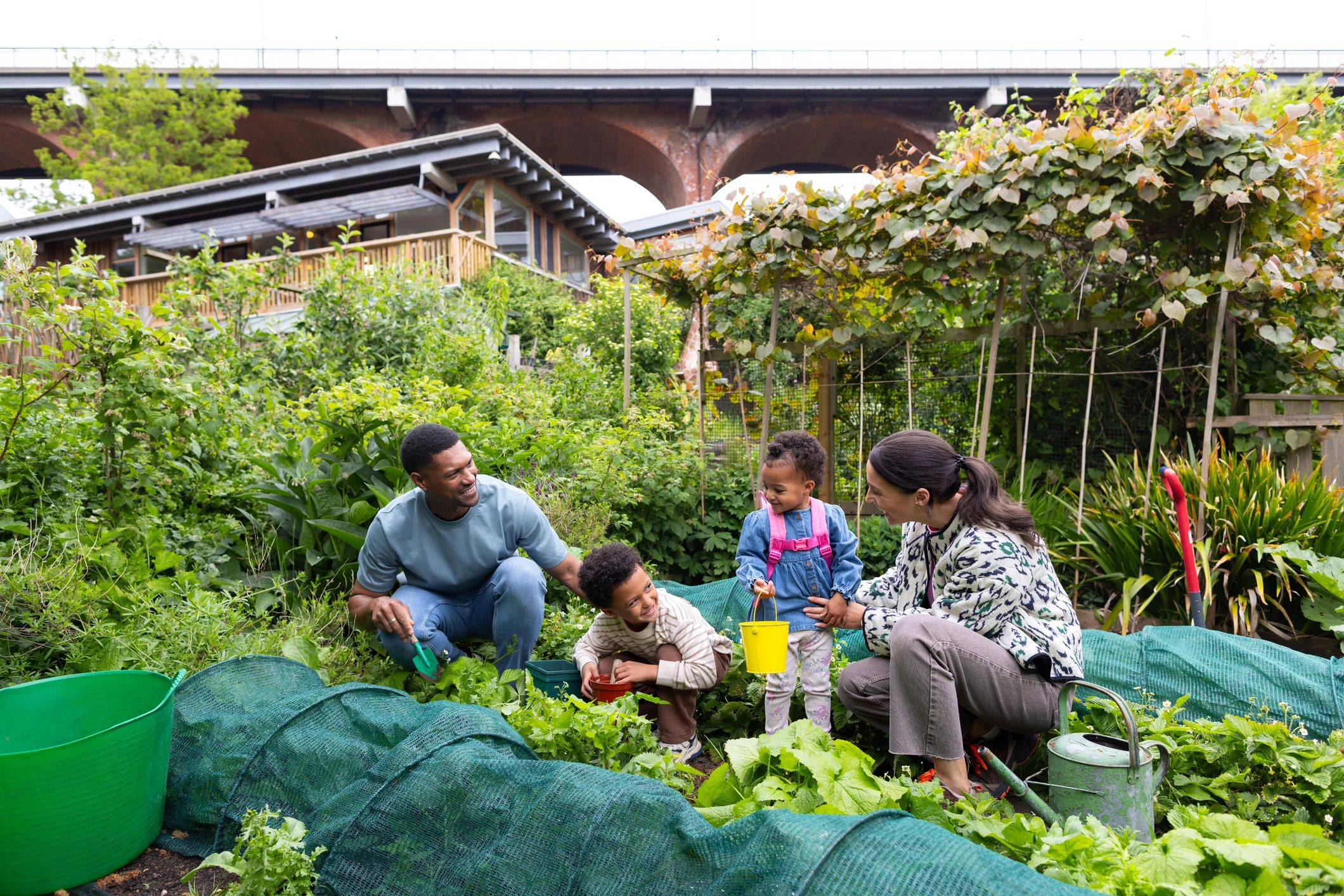 Family participating in hands-on gardening and sustainability activities